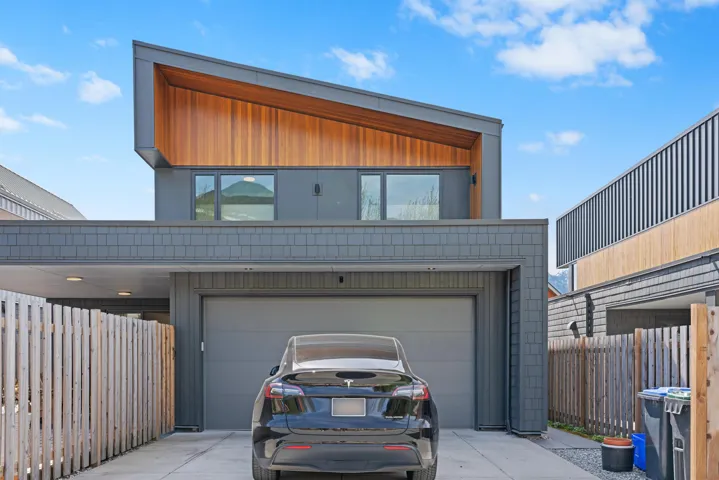 View of front of house featuring fence and driveway