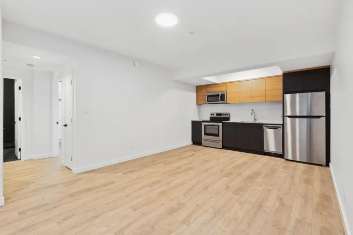 Kitchen with appliances with stainless steel finishes, light wood-style flooring, modern cabinets, recessed lighting, and open floor plan