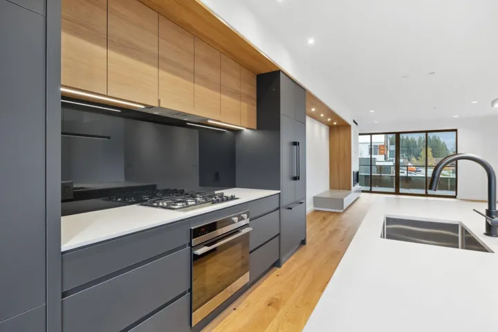 Kitchen featuring modern cabinets, light wood finished floors, appliances with stainless steel finishes, recessed lighting, and gray cabinets