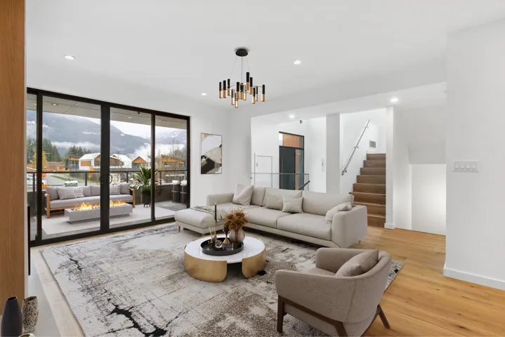 Living area with a mountain view, light wood finished floors, recessed lighting, stairway, and a chandelier