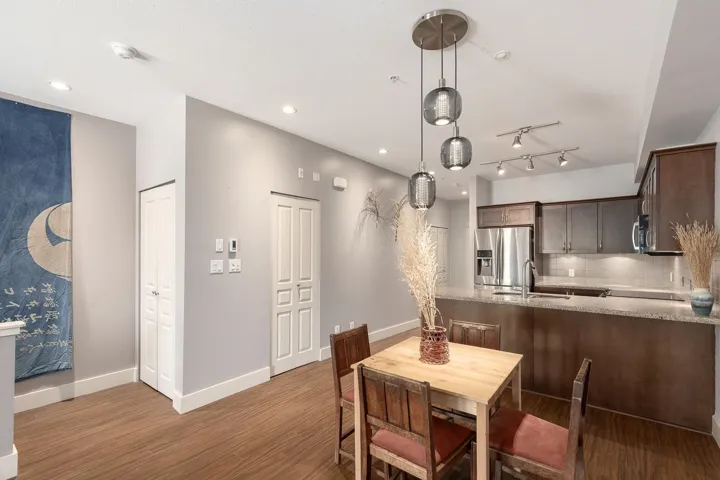 Kitchen and dining area featuring wood-finish flooring