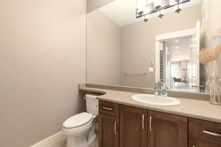 Vanity with a built-in oval sink, countertop, and dark wood-finish cabinetry