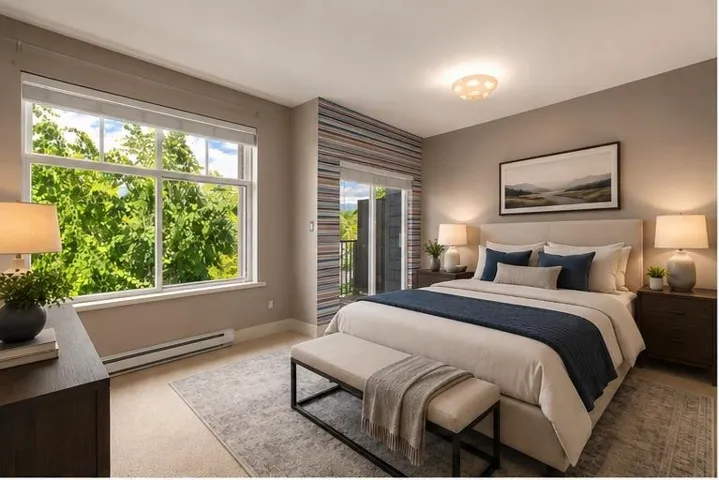 Large window with transom detailing, private balcony access, neutral wall tones, low-pile carpeting, and a built-in baseboard heater