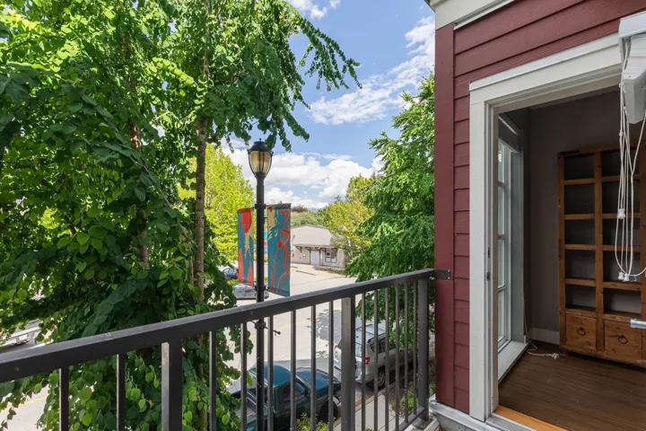 Balcony featuring black metal railings and a red siding exterior