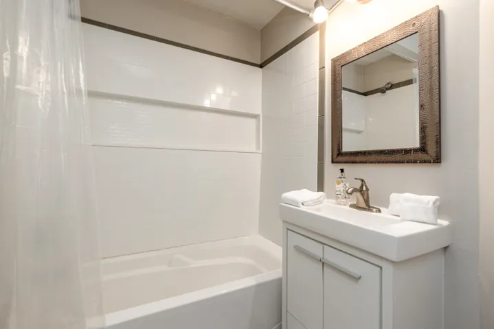 Bathroom featuring vanity and shower / bath combo with shower curtain
