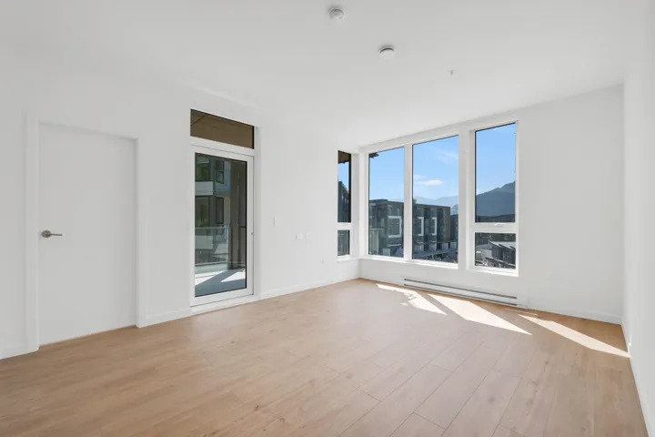 Spare room with a mountain view, light wood-type flooring, and a baseboard heating unit