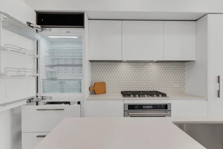 Kitchen view of stainless steel gas cooktop, white cabinetry, and light countertops