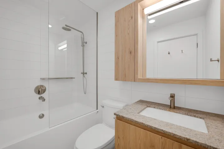 Kitchen featuring modern cabinets, white cabinets, light wood finished floors, appliances with stainless steel finishes, and recessed lighting