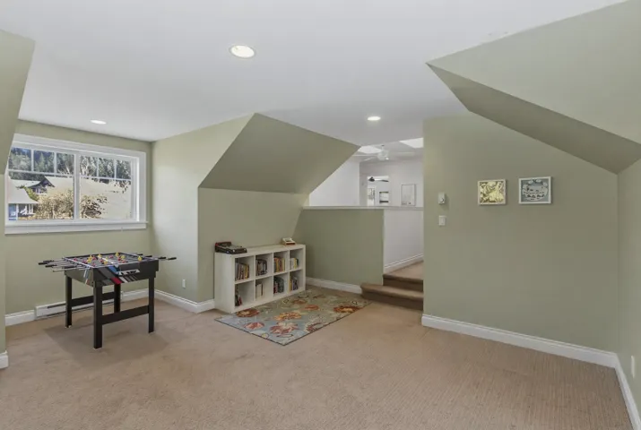 Playroom with light colored carpet, recessed lighting, and vaulted ceiling