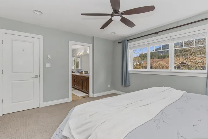 Master Bedroom featuring light carpet, ensuite bath, a ceiling fan, and recessed lighting
