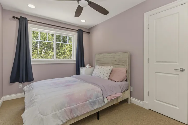 Bedroom with light colored carpet, a ceiling fan, and recessed lighting