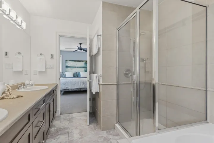 Full bathroom with ensuite bathroom, a shower stall, double vanity, and a garden tub