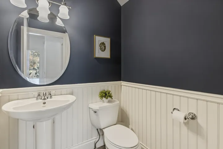 Bathroom featuring wainscoting and toilet