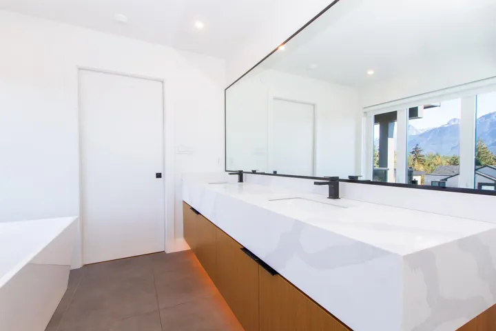 Bathroom with double vanity, recessed lighting, tile patterned floors, a tub to relax in, and a mountain view