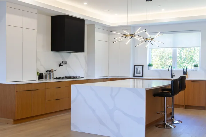 Kitchen featuring a breakfast bar, modern cabinets, light wood-type flooring, and light stone countertops