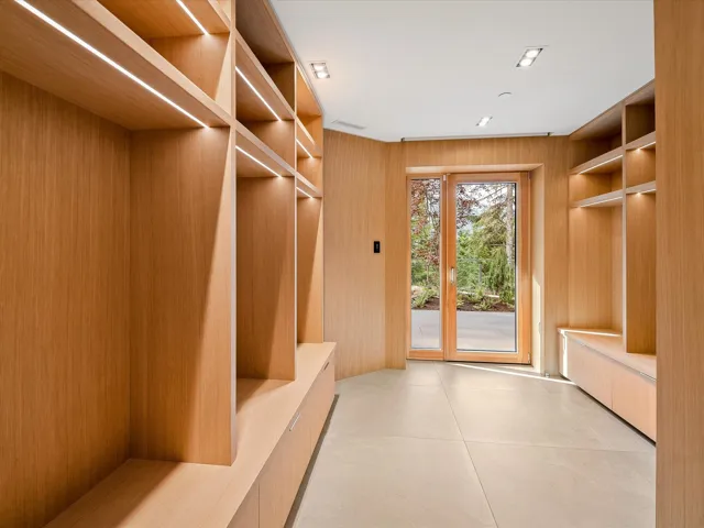 Mudroom featuring wood walls