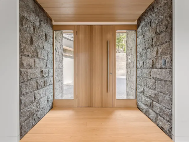 Spare room with concrete block wall, wood ceiling, and wood finished floors