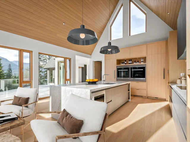 Kitchen with light brown cabinets, modern cabinets, high vaulted ceiling, open shelves, and light stone counters