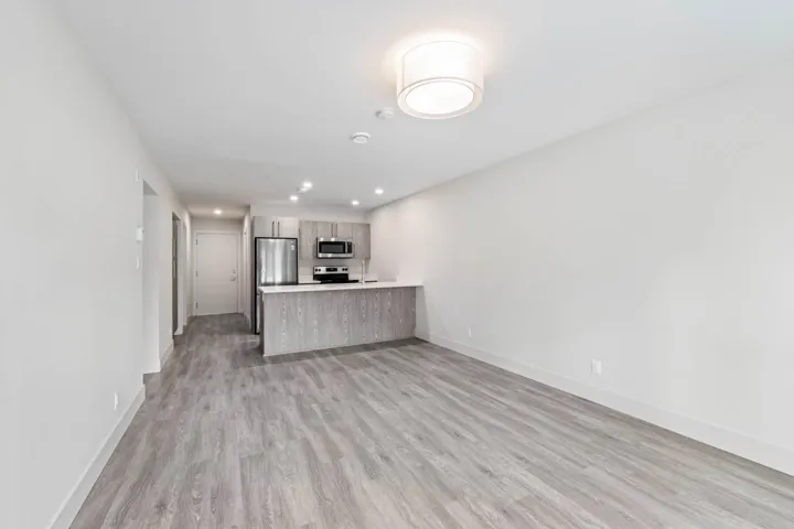 Unfurnished living room with baseboards, light wood finished floors, and recessed lighting