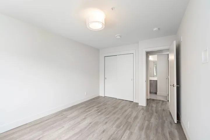 Unfurnished bedroom featuring light wood-style floors, a closet, and baseboards