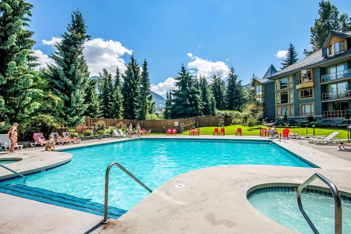 Community pool with a hot tub and a patio area