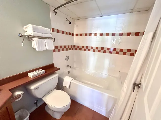 Bathroom with shower / bathtub combination with curtain and tile patterned floors