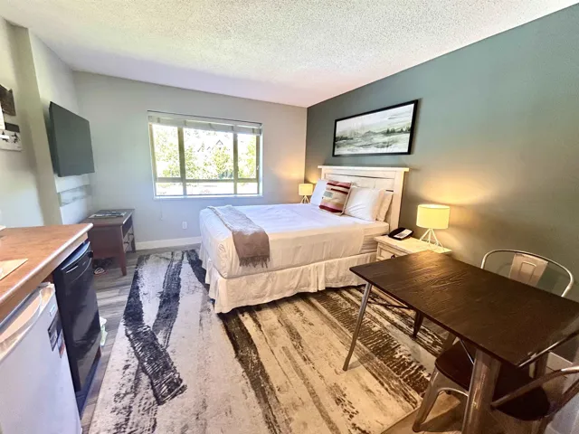 Bedroom featuring a textured ceiling and light wood-type flooring