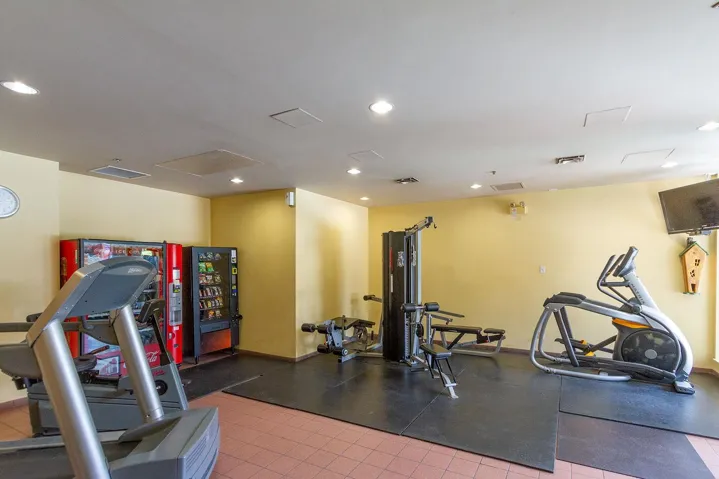 Workout area with recessed lighting and attic access