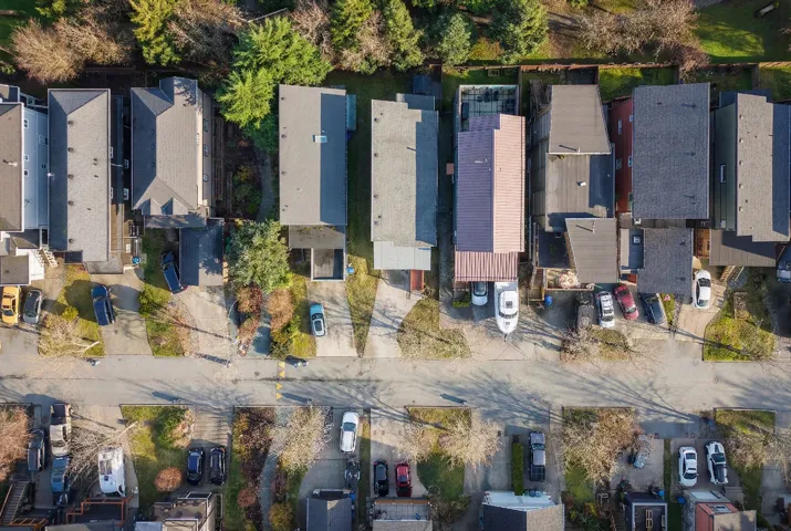 Aerial perspective showcasing multiple residential properties along a paved street