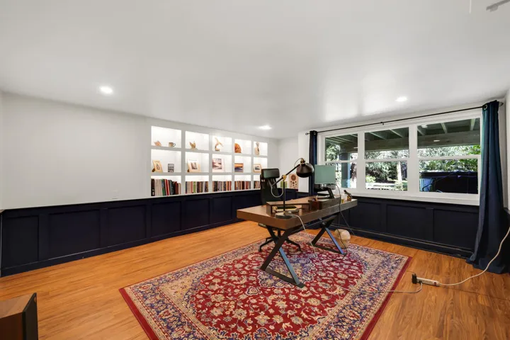 Recessed lighting illuminates built-in shelving with integrated lighting