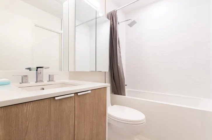Bathroom featuring shower / bath combination with curtain and vanity