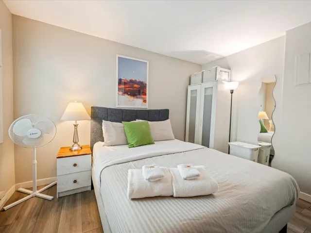 Bedroom featuring wood finished floors and baseboards