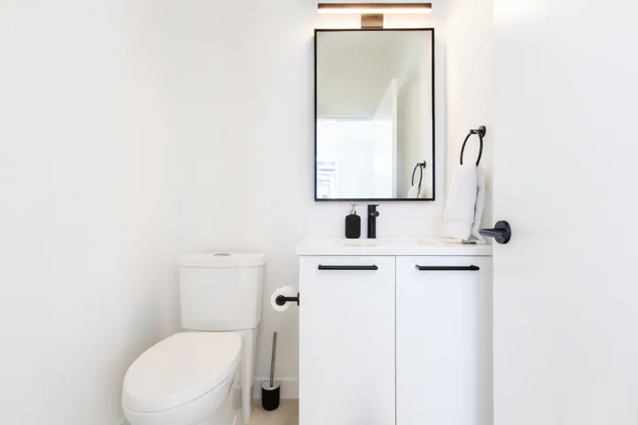 Half bathroom with vanity and toilet