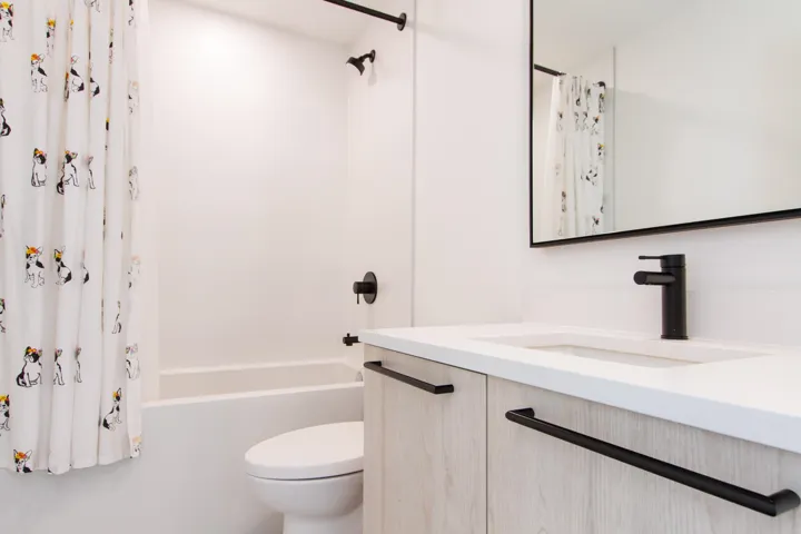 Bathroom featuring vanity, toilet, and shower / tub combo with curtain