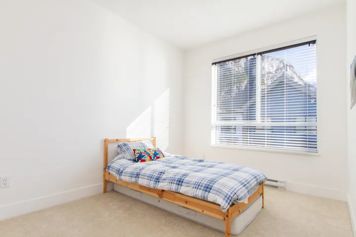 Bedroom featuring a baseboard radiator, baseboards, and carpet flooring