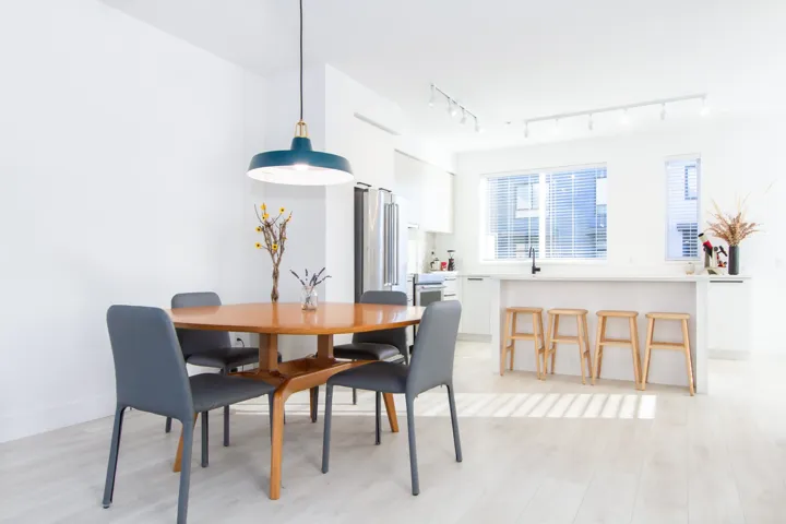Dining area with light wood-style flooring, baseboards, and track lighting
