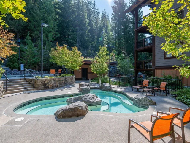 View of swimming pool with a patio area, an outdoor structure, and stairway