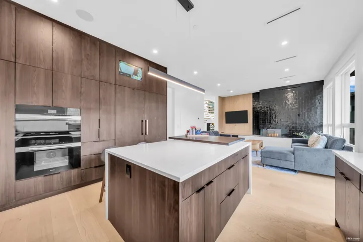 Spacious kitchen island with a white countertop and wood-finish cabinetry