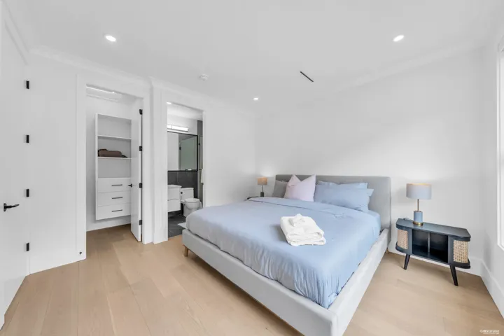 Bedroom with light wood-finish flooring, recessed lighting, and crown molding