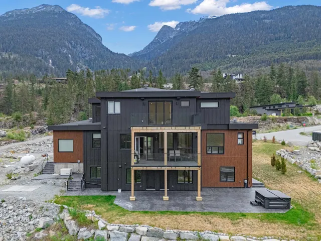 Modern multi-level residence featuring a dark facade with wood-finish paneling accents