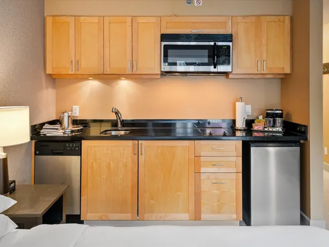 Kitchen featuring light brown cabinets and appliances with stainless steel finishes