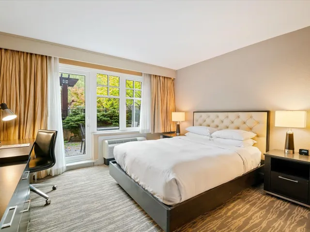 Bedroom featuring a desk and a wall mounted AC