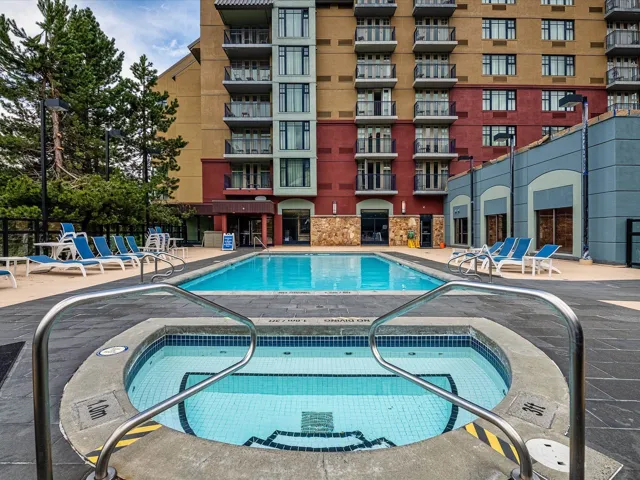 Community pool with a hot tub and a patio area