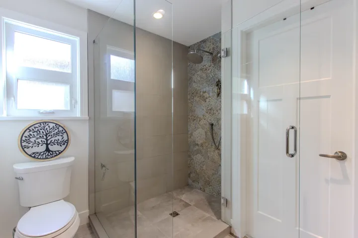 Bathroom with a stall shower and toilet