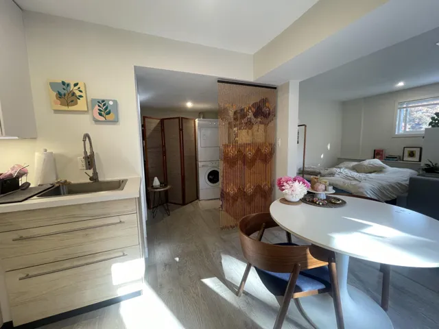 Dining room featuring light wood-type flooring and stacked washer / dryer