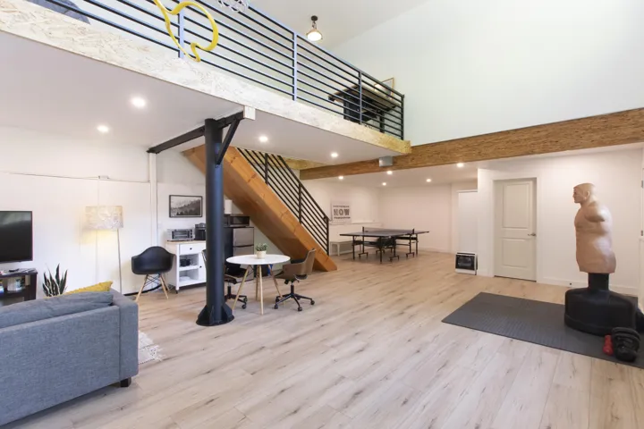 Living room with a towering ceiling, light wood-style flooring, recessed lighting, and stairway