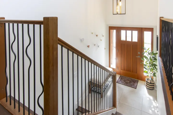 Foyer entrance with tile patterned floors and stairs