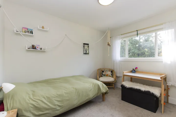 Carpeted bedroom with baseboards