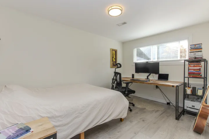Bedroom with an office area and light wood finished floors