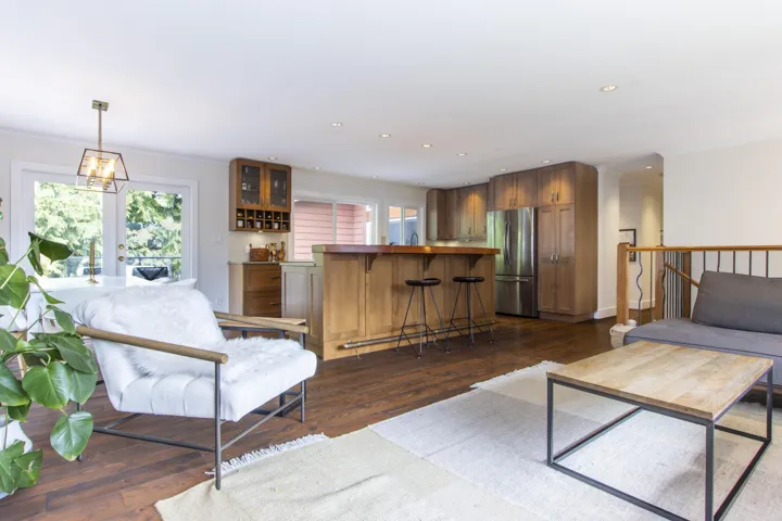 Living area featuring plenty of natural light, dark wood finished floors, french doors, crown molding, and recessed lighting